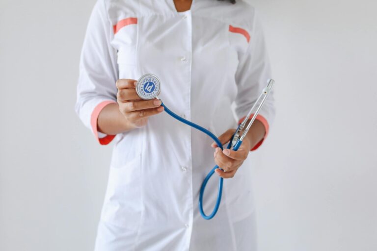 Close-up of a female doctor holding a blue stethoscope, emphasizing healthcare and professionalism.