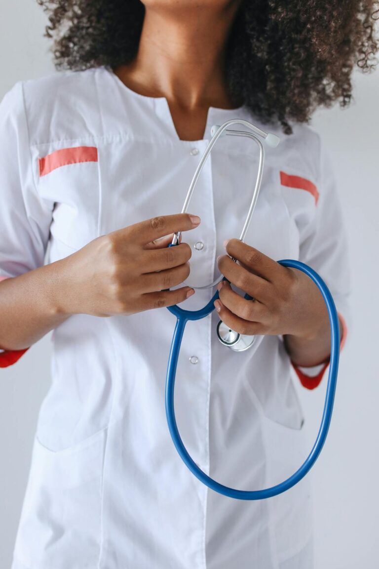 Close-up of a healthcare worker holding a stethoscope, highlighting medical professionalism.